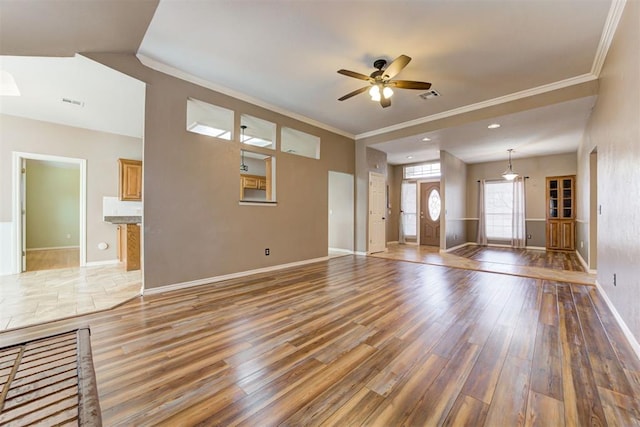 unfurnished living room with baseboards, light wood finished floors, visible vents, and crown molding