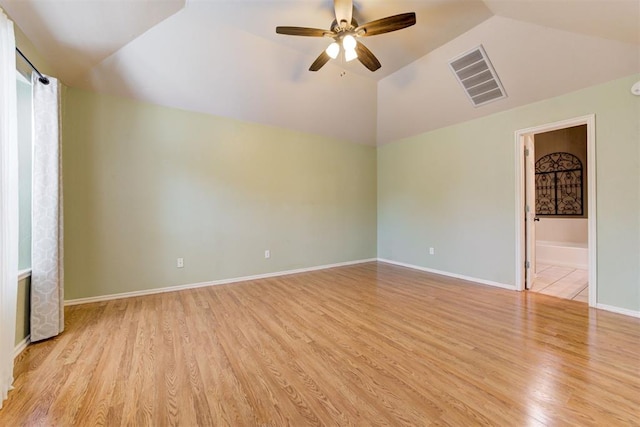 unfurnished room featuring light wood finished floors, visible vents, vaulted ceiling, ceiling fan, and baseboards