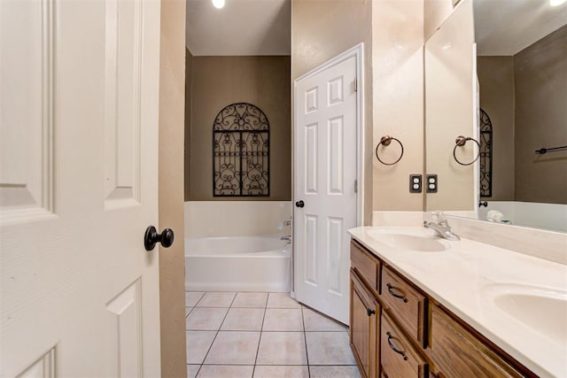 bathroom with double vanity, a sink, a bath, and tile patterned floors