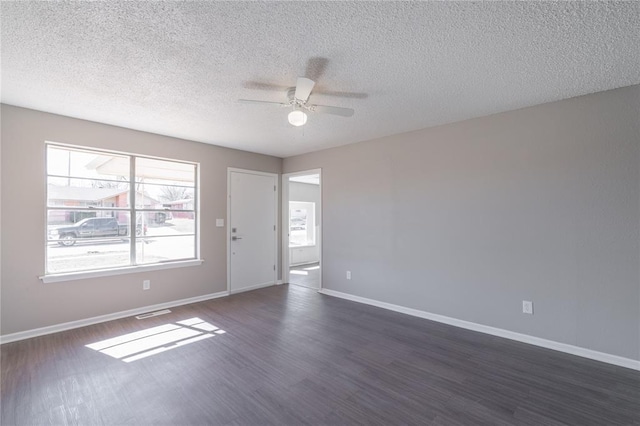 unfurnished room with baseboards, a textured ceiling, dark wood finished floors, and ceiling fan