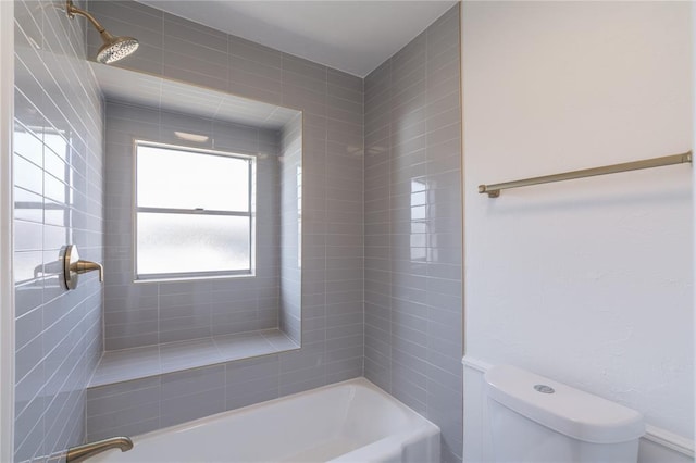 bathroom with washtub / shower combination and toilet
