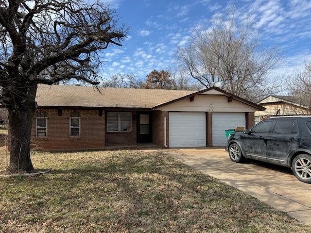 ranch-style house with a front lawn, concrete driveway, brick siding, and an attached garage