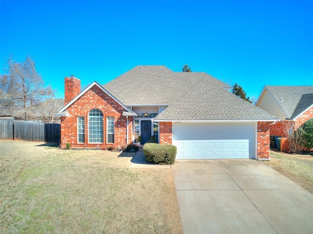 view of front facade with a chimney, concrete driveway, an attached garage, fence, and a front lawn