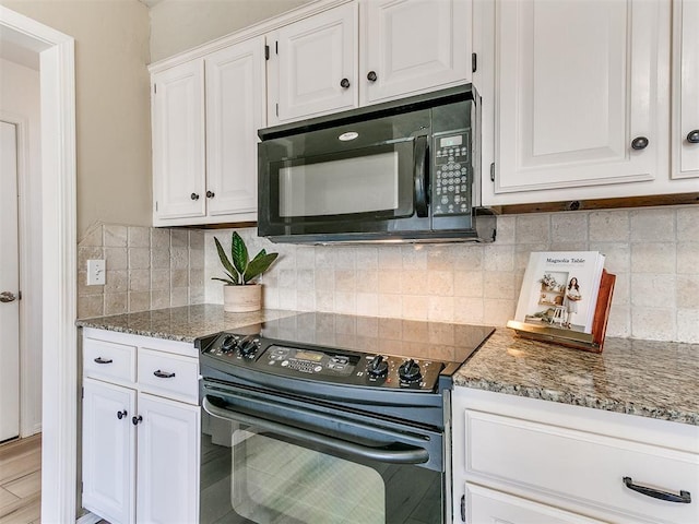 kitchen featuring dark stone countertops, white cabinetry, decorative backsplash, and black appliances