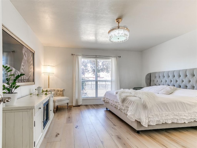 bedroom with light wood finished floors and baseboards