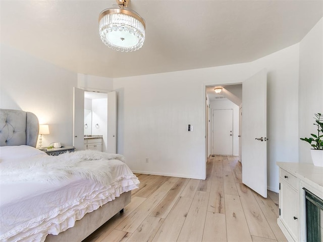 bedroom with light wood-type flooring, wine cooler, and baseboards