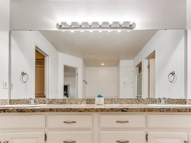 bathroom with double vanity and a sink