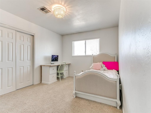 bedroom with carpet floors, a closet, and visible vents