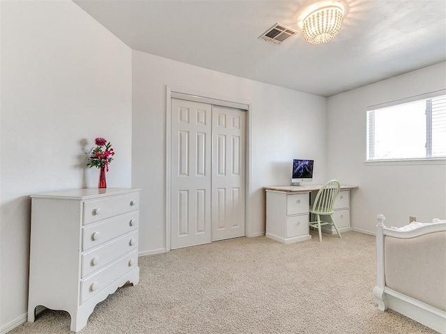 office area with baseboards, visible vents, and light colored carpet