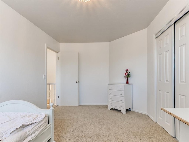 bedroom featuring a closet and light colored carpet