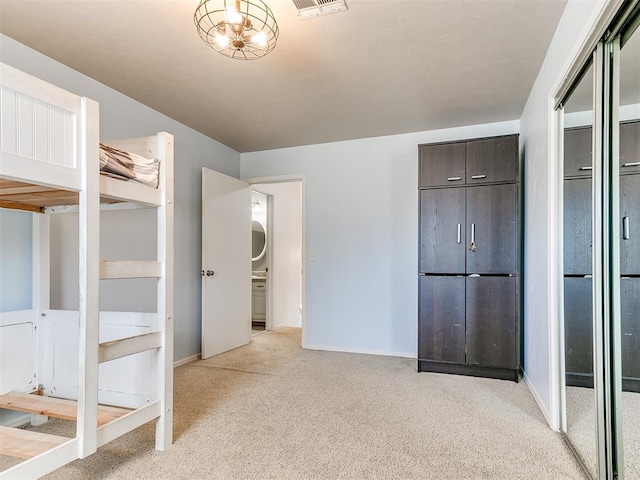 unfurnished bedroom featuring baseboards, visible vents, and light colored carpet