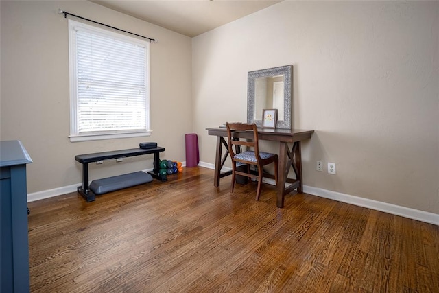 office area with baseboards and wood finished floors