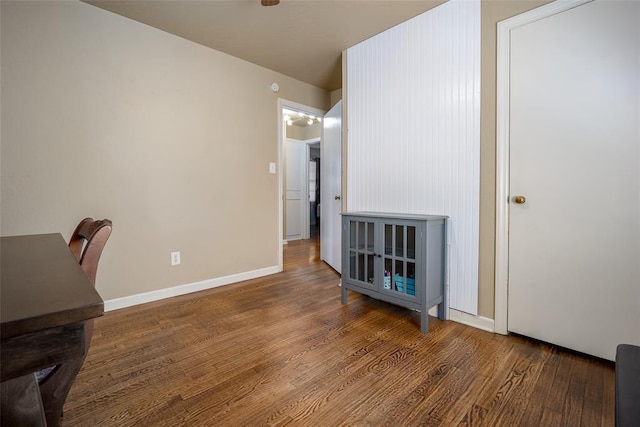 interior space featuring baseboards and wood finished floors