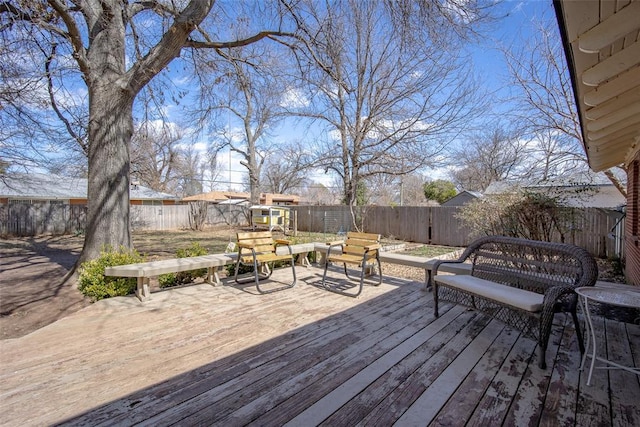 wooden deck featuring a fenced backyard