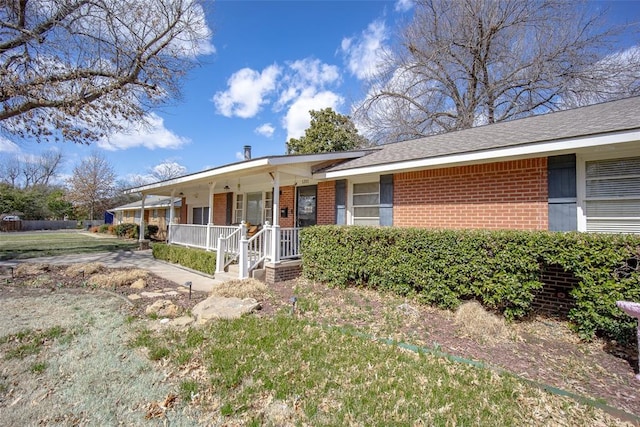 ranch-style house with covered porch and brick siding