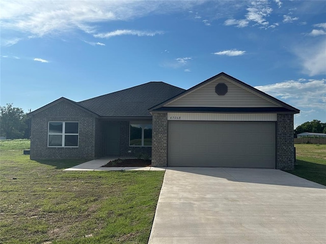 43068 Wagon Trl, Shawnee, OK 74804 - single story home with brick siding, driveway, a garage, and a front lawn