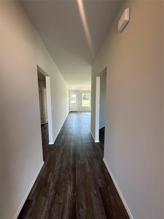43068 Wagon Trl, Shawnee, OK 74804 - corridor with dark wood finished floors and baseboards