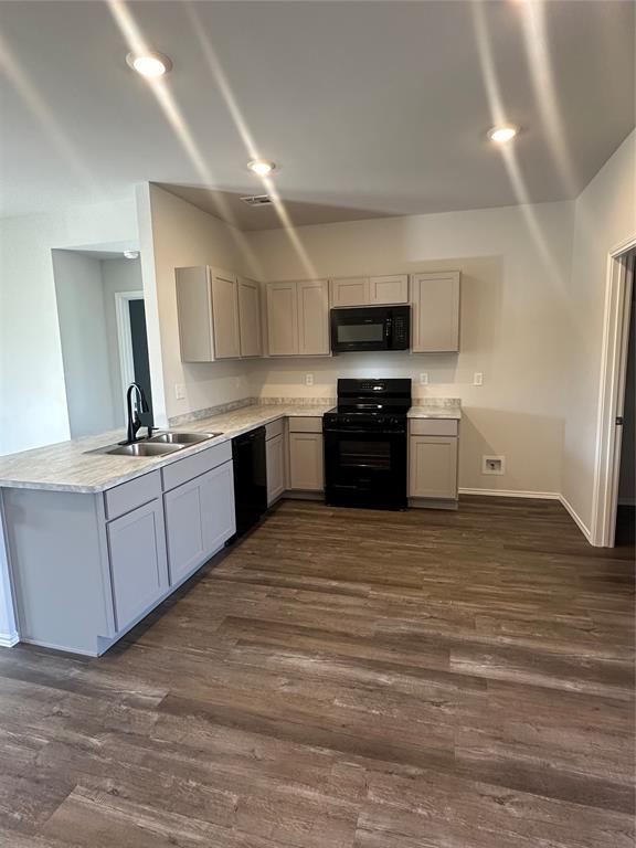 43068 Wagon Trl, Shawnee, OK 74804 - kitchen with black appliances, gray cabinetry, dark wood-style flooring, and light countertops