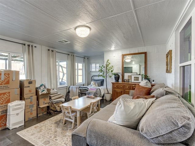 living room with visible vents and a textured ceiling