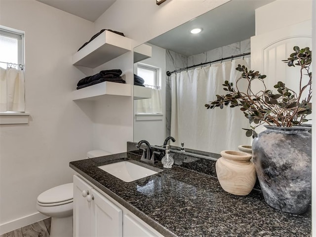 bathroom featuring toilet, vanity, wood finished floors, a shower with curtain, and baseboards