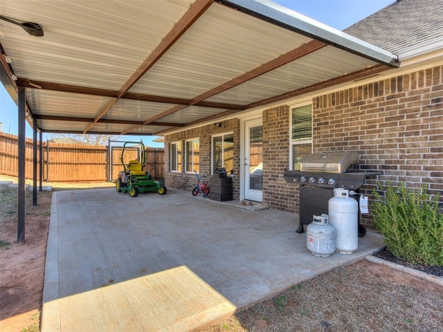 view of patio featuring a carport, fence, and area for grilling