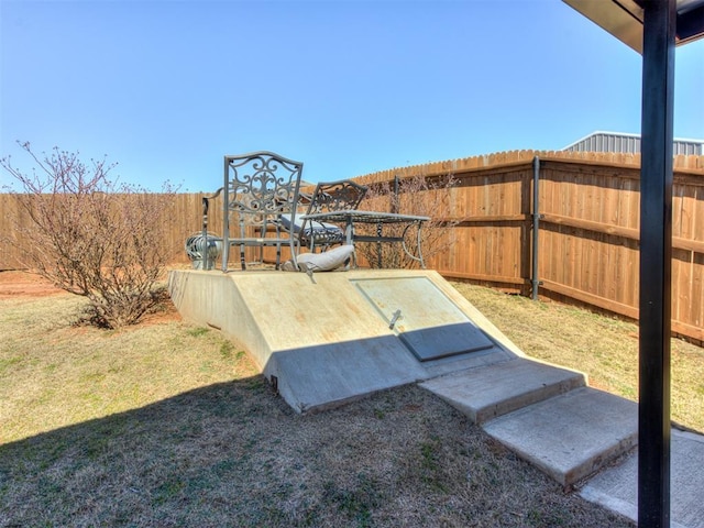 view of storm shelter with a yard and fence