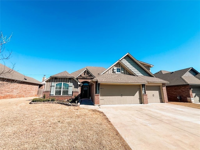 view of front of house featuring a garage, concrete driveway, brick siding, and board and batten siding