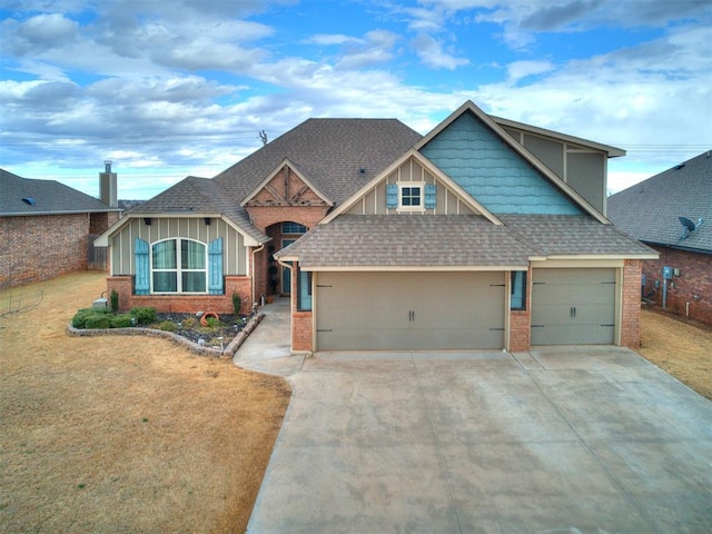 craftsman-style house featuring brick siding, board and batten siding, a front yard, a garage, and driveway