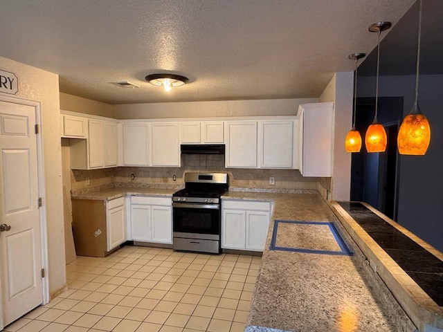 kitchen featuring tasteful backsplash, gas stove, visible vents, and white cabinets