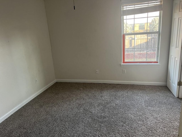 spare room with carpet flooring and baseboards