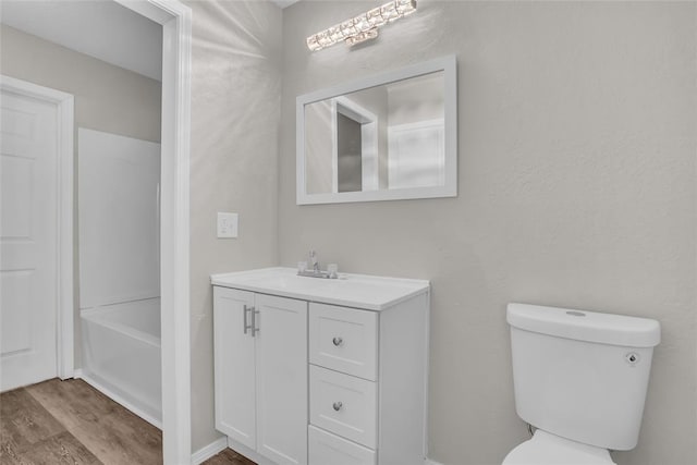 full bathroom with vanity, wood finished floors, and toilet