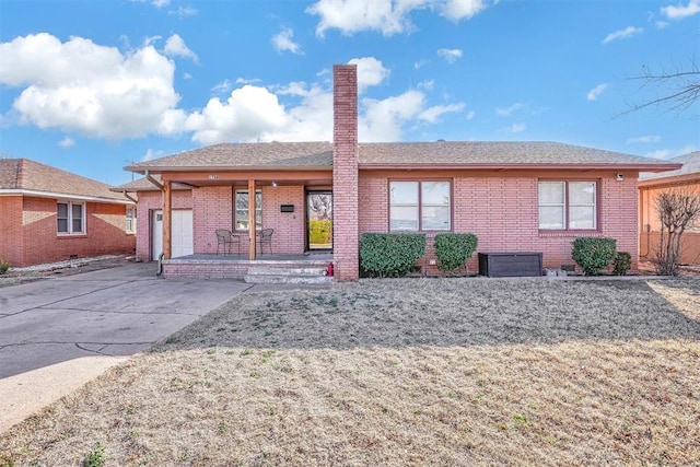 single story home featuring covered porch, brick siding, a chimney, and concrete driveway