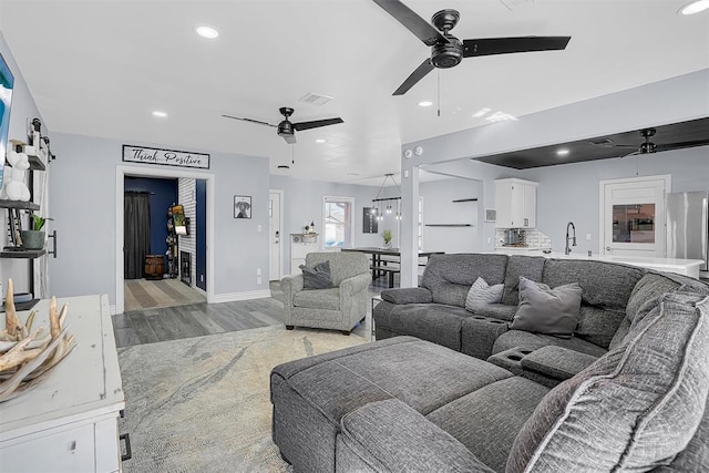 living room with ceiling fan, baseboards, wood finished floors, and recessed lighting