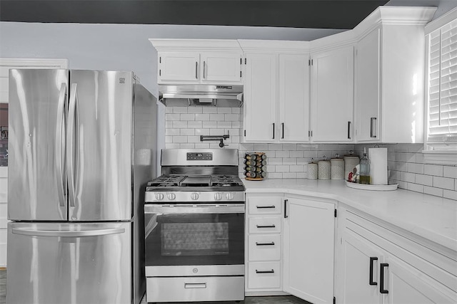 kitchen featuring tasteful backsplash, light countertops, appliances with stainless steel finishes, white cabinets, and under cabinet range hood