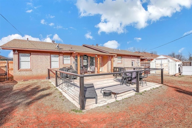 rear view of house with brick siding, fence, a storage unit, an outdoor structure, and outdoor dining space