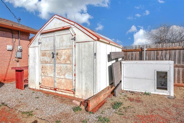 view of shed with fence