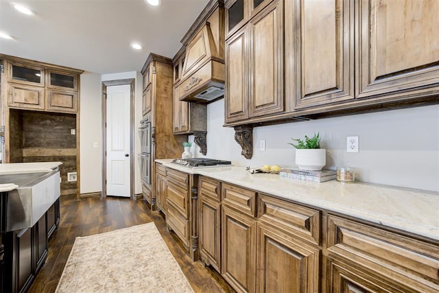 kitchen featuring dark wood-style floors, stainless steel appliances, and glass insert cabinets