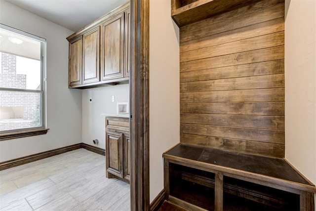 mudroom with light wood-style floors and baseboards