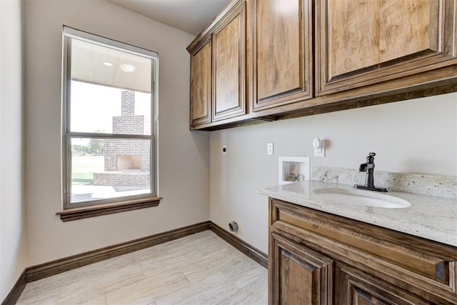 laundry area featuring washer hookup, a sink, baseboards, cabinet space, and electric dryer hookup