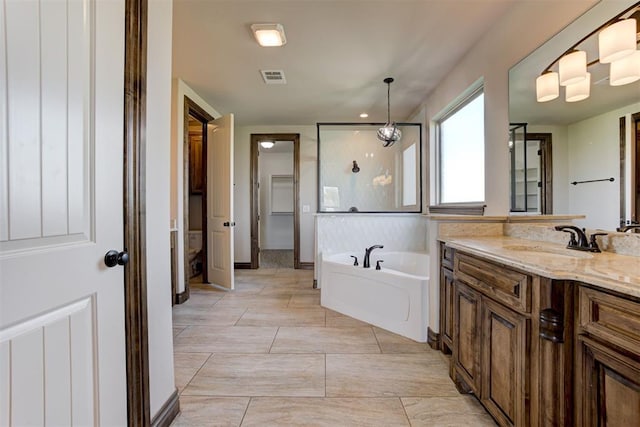 full bath with visible vents, a garden tub, and vanity