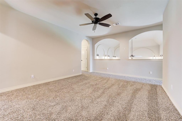 spare room featuring ceiling fan, carpet flooring, visible vents, and baseboards