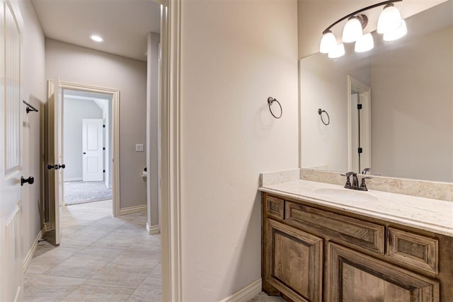 bathroom with vanity and baseboards