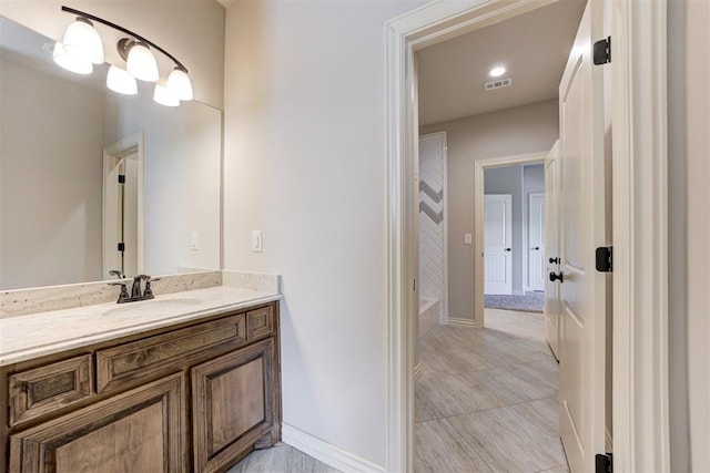 bathroom featuring vanity, visible vents, baseboards, a shower, and a bathtub