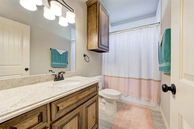 full bathroom with shower / bathtub combination with curtain, a notable chandelier, vanity, and toilet