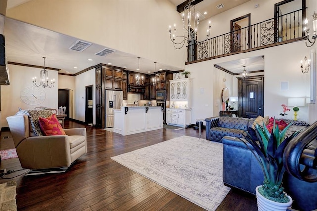 living room with a chandelier, visible vents, crown molding, and dark wood-style floors