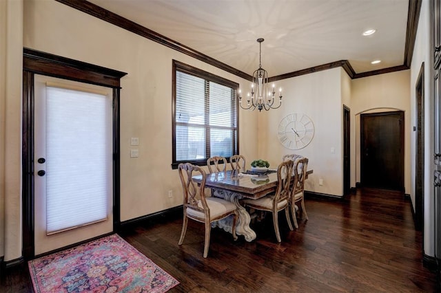 dining space featuring a notable chandelier, crown molding, dark wood-type flooring, and baseboards