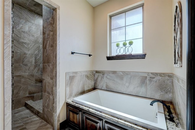 full bath featuring a bath and tiled shower