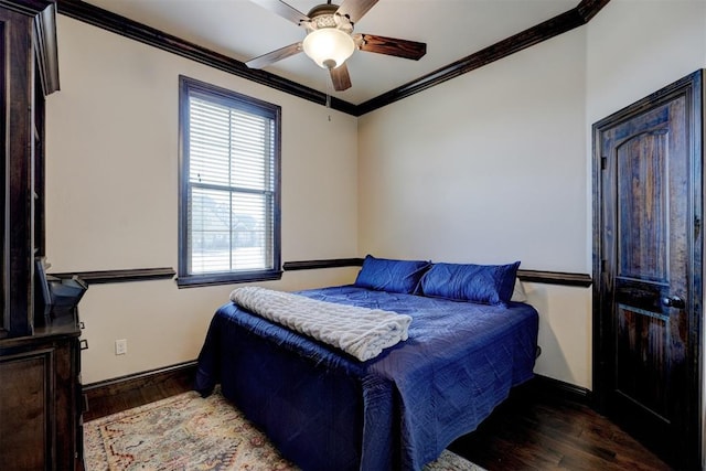 bedroom featuring ceiling fan, baseboards, wood finished floors, and crown molding