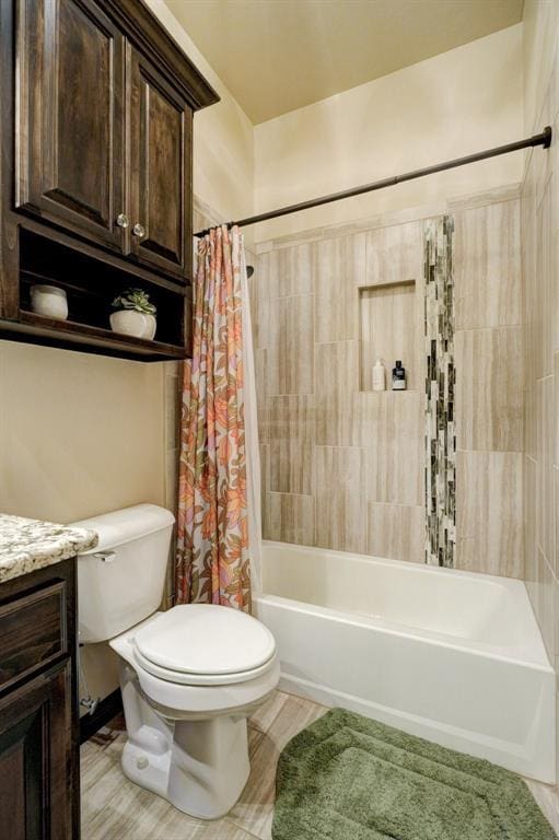 full bath with vanity, toilet, and shower / tub combo with curtain