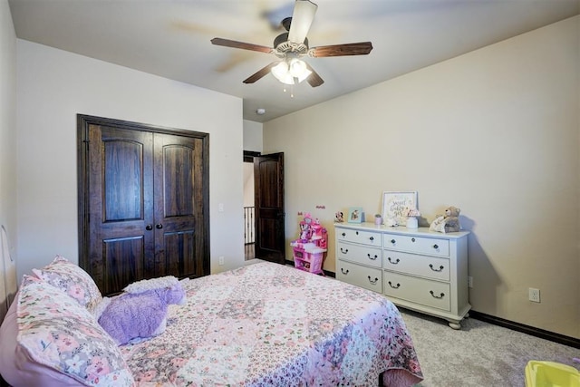 bedroom featuring baseboards, a ceiling fan, a closet, and light carpet